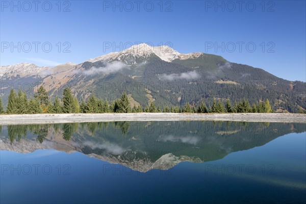 Water reservoir for snow production for the ski slopes on Grubigstein with view to Daniel