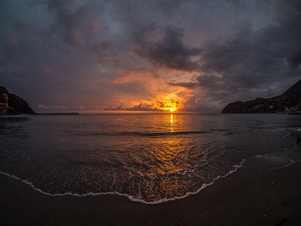 Sunset behind clouds over the sea