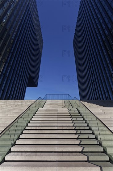 Wide staircase leading upwards between skyscrapers