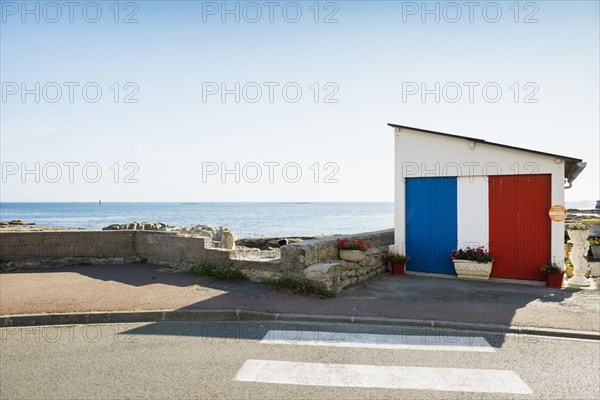 Garage by the sea painted in French national colours