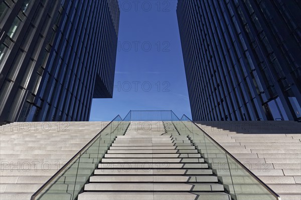 Wide staircase leading upwards between skyscrapers