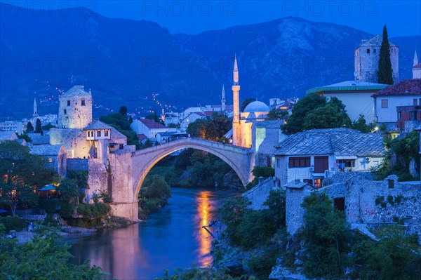 Mostar Bridge over Neretva river at sunset