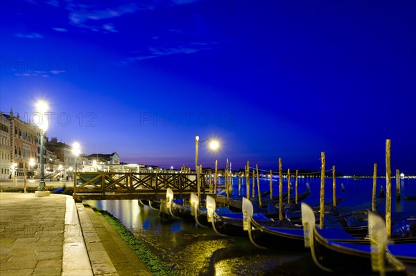 Gondolas at the quay of Riva degli Schiavoni at dusk