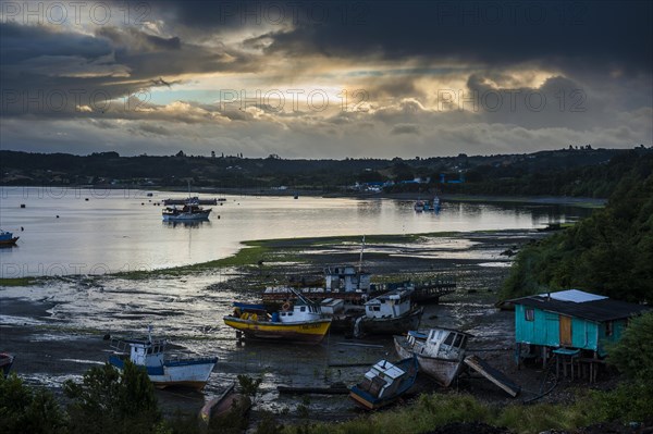 Fishing boats at low tide and sunset in Dalcahue