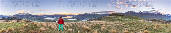 Hiker overlooking Lake Wanaka and mountains