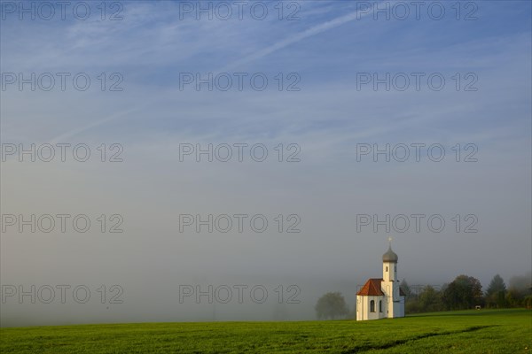 St. Johannisrain near Penzberg in the morning fog of Upper Bavaria