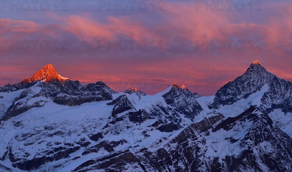 Zinalrothorn with snow in red dawn glow