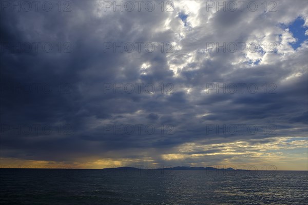 Thunderclouds at sunset on the beach