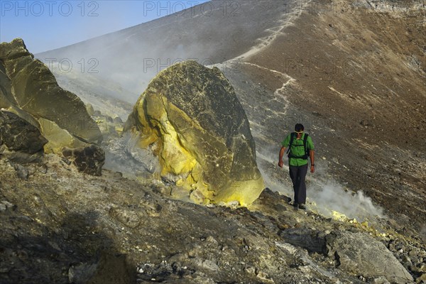 Hiker on the Gran Cratere walks through sulphur fumaroles