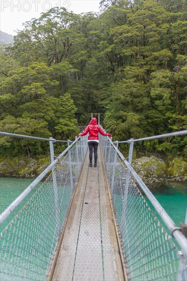 Woman crossing Suspension Bridge