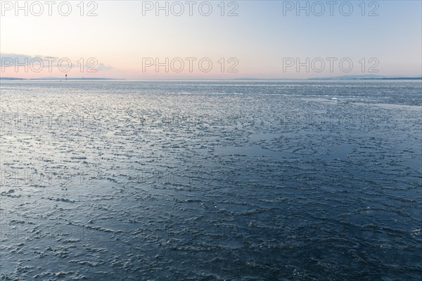Ice on the shore of Lake Constance on a winter evening