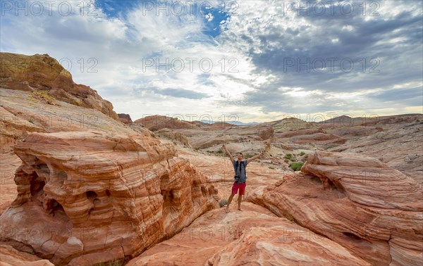 Young man posing with outstretched arms