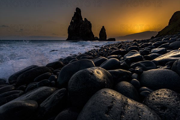 Rock formation Ribeira de Janela at sunrise with black stones at the beach