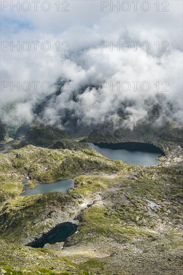 Clouds passing over a ridge with mountain lakes
