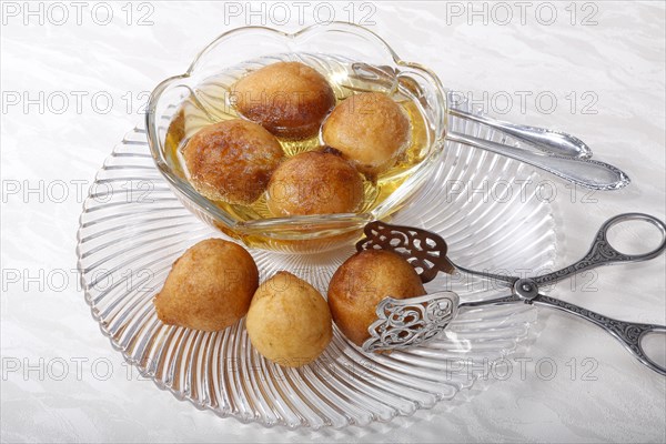 Swabian dessert on glass plate with pastry tongs