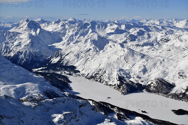 Snow-covered Lake Sils with snow-covered mountains