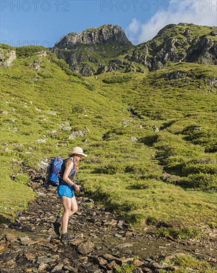 Hiker crossing a stream bed