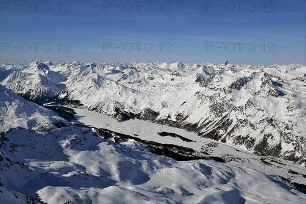 Snow-covered Lake Sils with snow-covered mountains