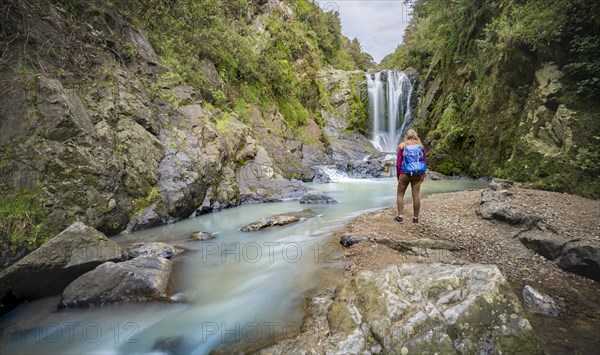 Hiker in front of Piroa Waterfall