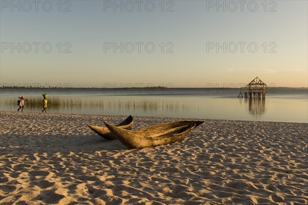 Dugout boat lying on sandy beach