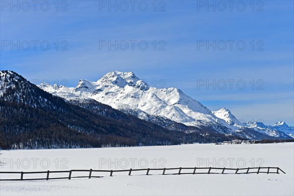 Summit Piz de la Margna above the frozen Lake Silvaplana