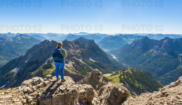 Hiker with views of mountains and Alps