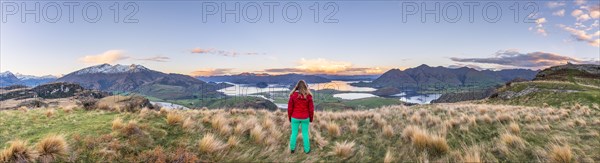 Hiker overlooking Lake Wanaka and mountains