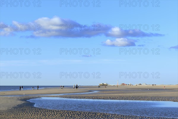 Sandy beach with walkers