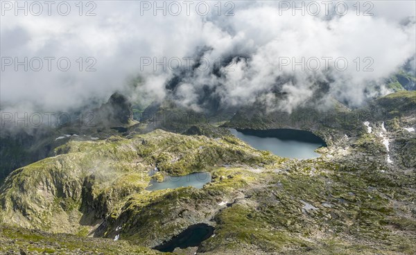 Clouds passing over a ridge with mountain lakes