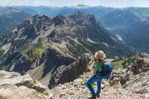 Hiker overlooks mountains and Alps