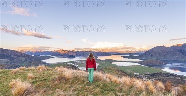 Hiker overlooking Lake Wanaka and mountains