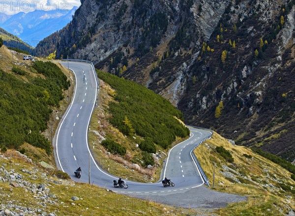 Motorcycles in a hairpin curve on mountain road