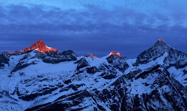 Zinalrothorn with snow in red dawn glow