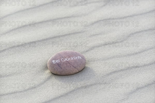 Be Happy inscribed in small stone