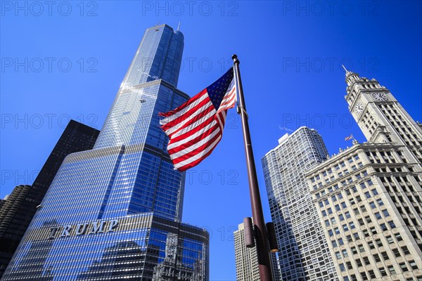 American flag in front of Trump Tower Chicago and Wrigley Building
