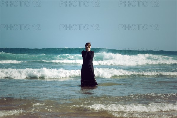 Woman in black dress with mask