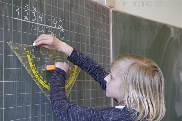 Student calculating on the blackboard