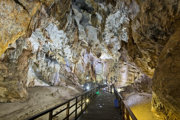 Boardwalk through illuminated dripstone cave