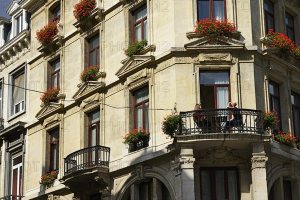 Young woman having breakfast on the balcony