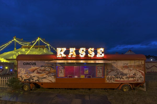 Counter of a travelling circus illuminated at dusk
