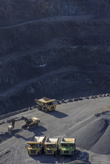 Tipper loader and excavator in a basalt quarry