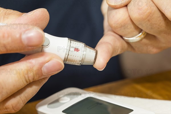 Diabetics taking a blood glucose test