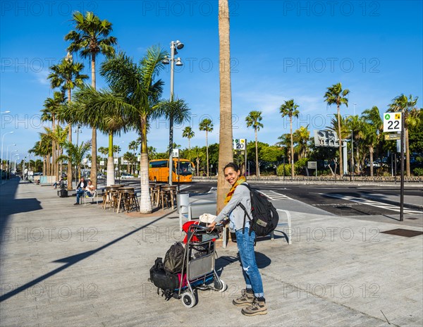 Young woman with trolley with luggage