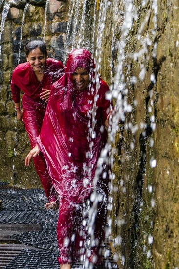 Two female pilgrims running through the 108 holy wells