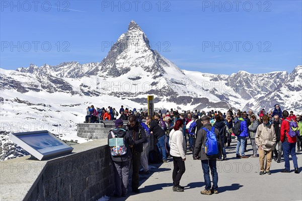 Tourists on the Gornergrat ridge with Matterhorn in the background