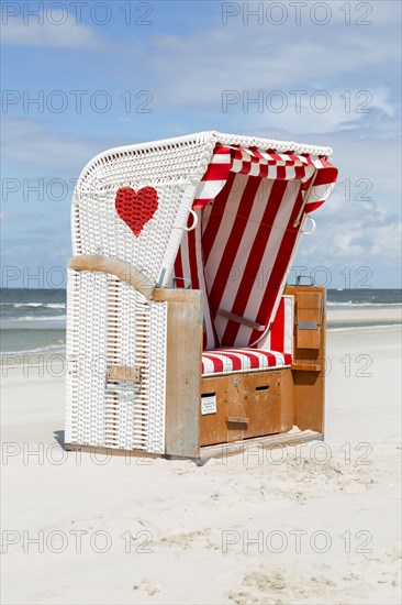Beach chair with red heart on the beach