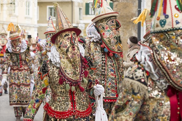 Ausseer Flinserl disguised people in costume with face masking or Gugl and hat