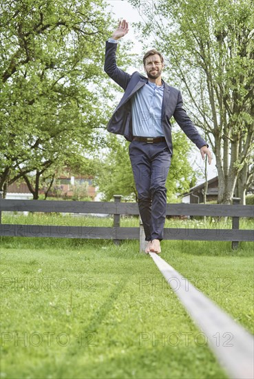 Manager balancing on slackline