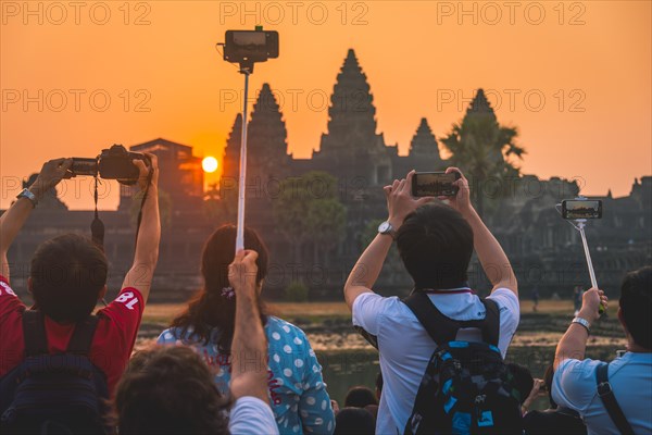 Tourists take pictures of Angkor Wat