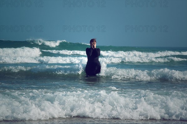 Woman in black dress with mask
